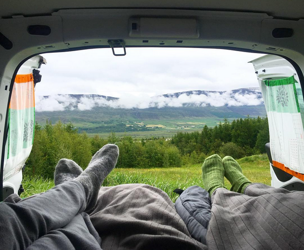 Inside a campervan in Iceland with a scenic mountain view, highlighting the freedom of waking up anywhere