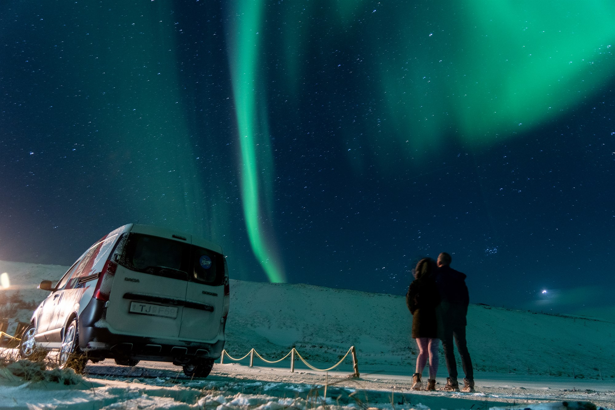 Campervan under the northern lights in Iceland, where sleep becomes optional and regret nonexistent.