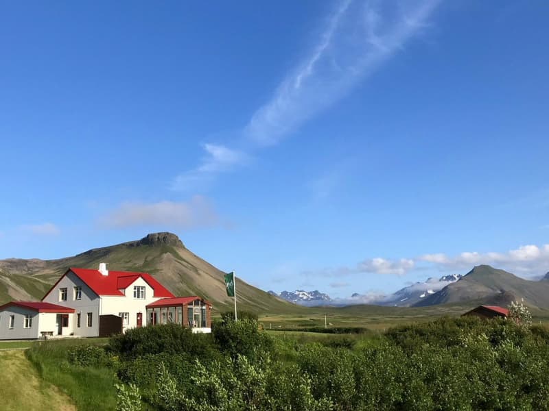 Traditional countryside hotel in Iceland surrounded by mountains and open landscapes during a Ring Road road trip.