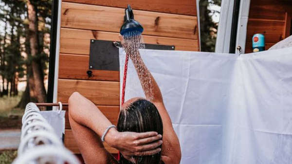 Simple outdoor campervan shower setup in Iceland, perfect after muddy hikes and questionable weather decisions.
