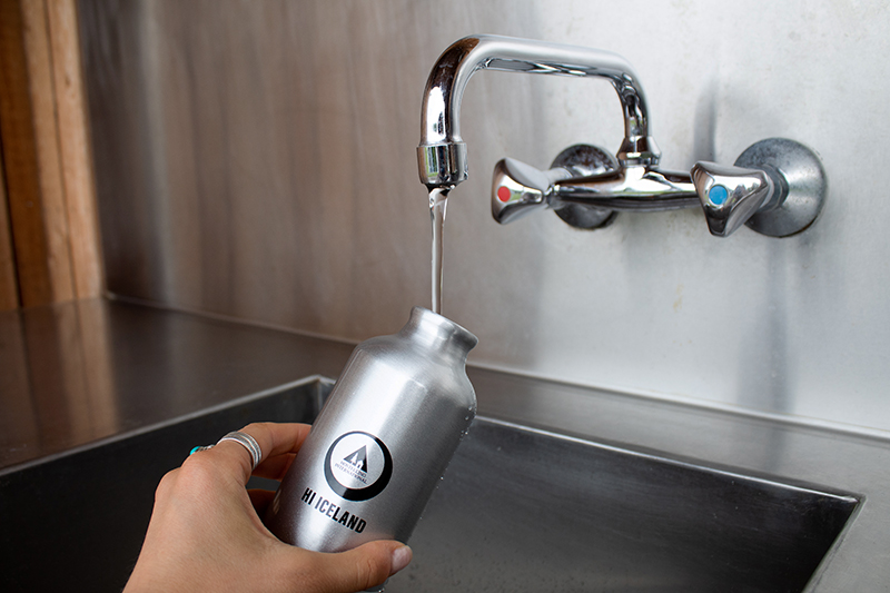 Reusable bottle being filled with tap water in Iceland, showing how easy it is to access clean and safe drinking water anywhere.