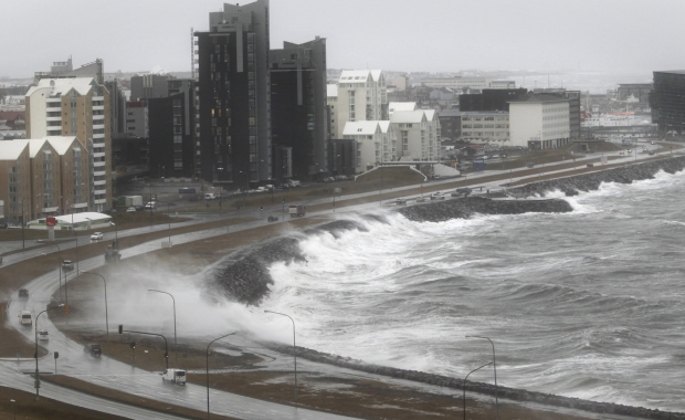 Waves crash against the Reykjavík coast during a severe storm, a reminder of Iceland’s unpredictable weather conditions during a campervan trip.